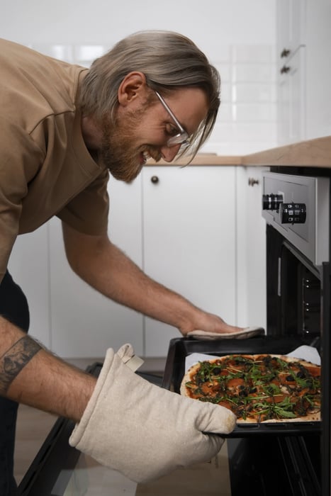 medium-shot-man-cooking-pizza